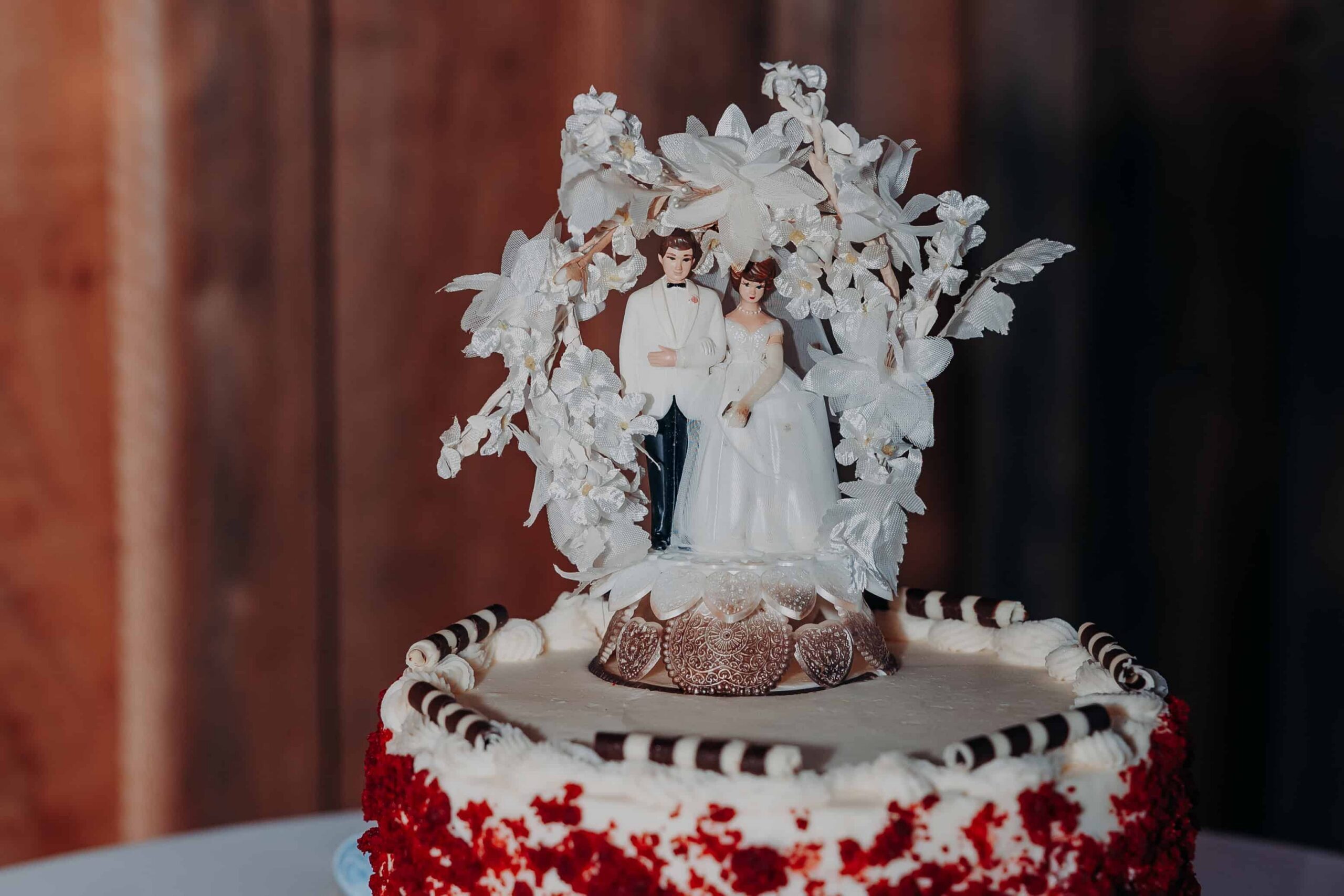 Vintage heirloom wedding cake topper detail on red velvet cake at Brown's Grove Farm