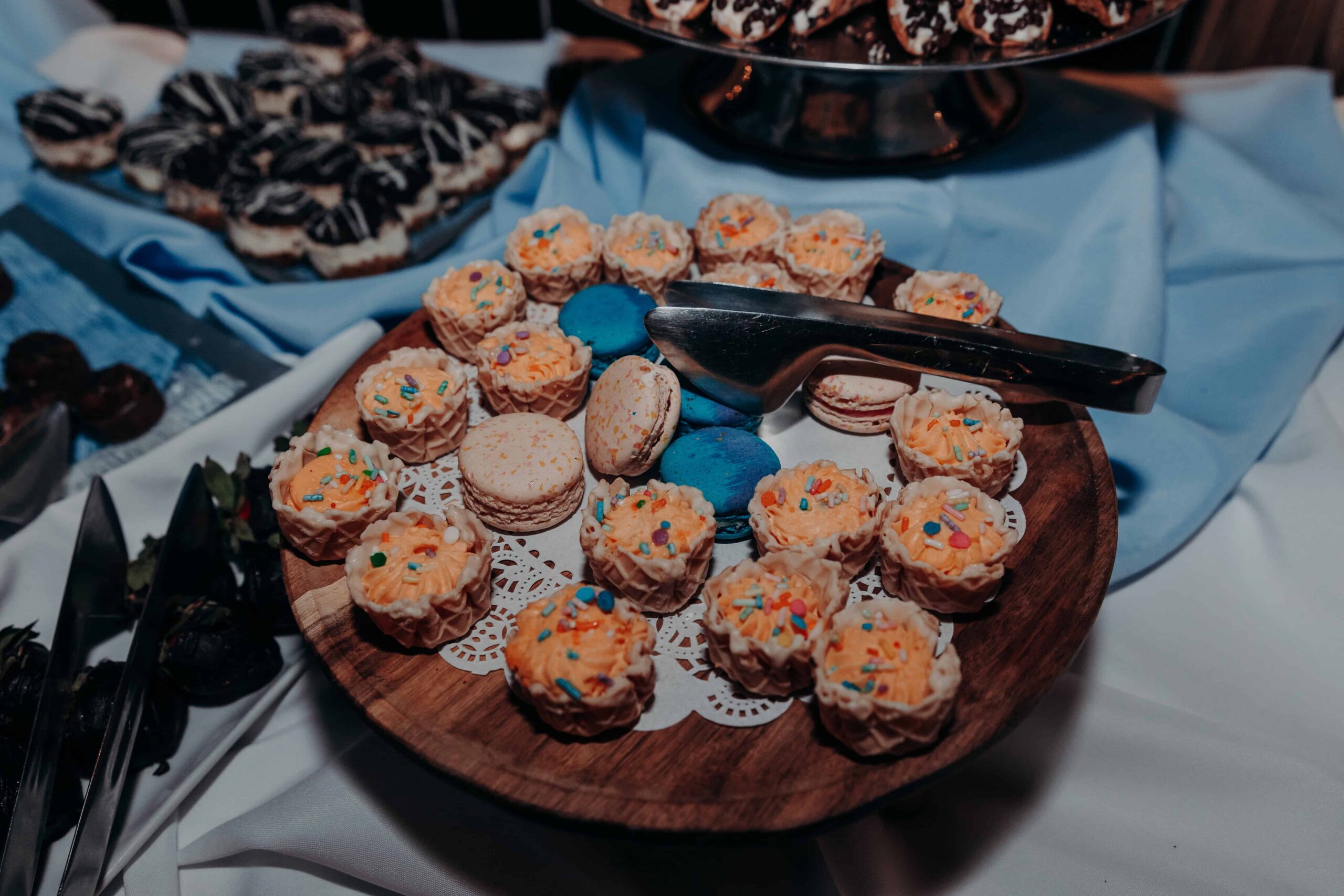 Dessert table display with mini cupcakes macarons and sweets at Brown's Grove Farm wedding reception