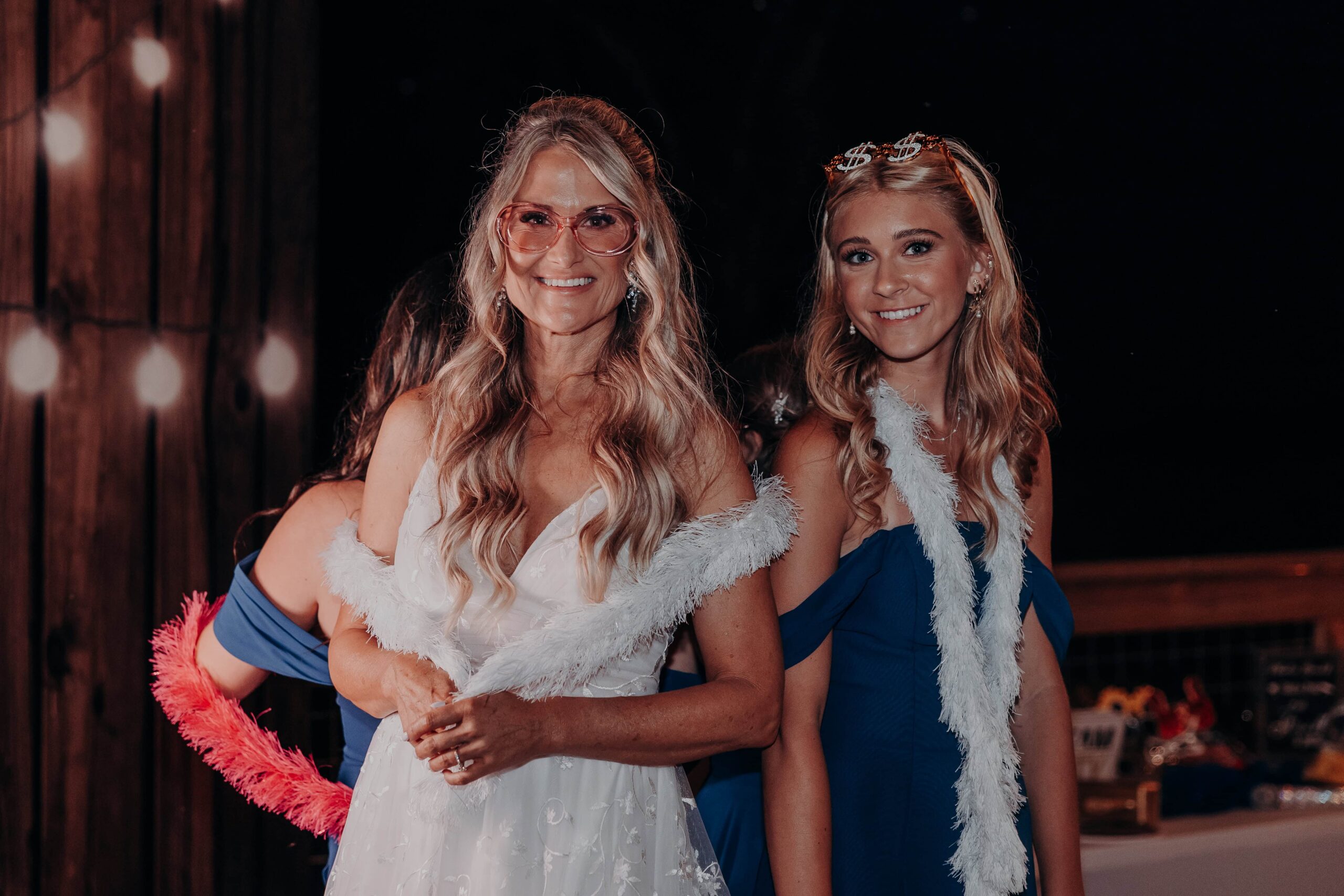 Bride and daughter with feather boa photo booth props at Brown's Grove Farm wedding reception