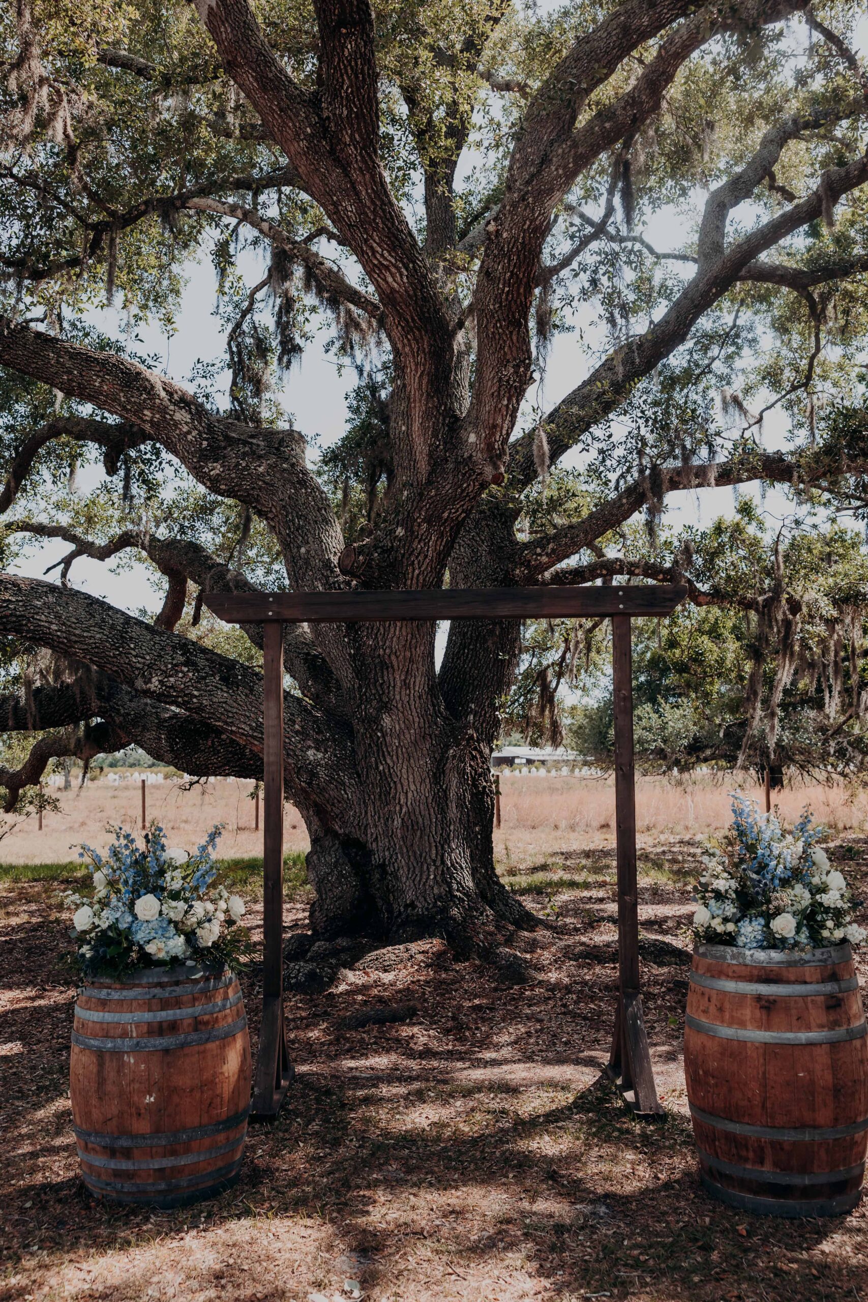 Wedding altar with wine barrels and floral arch at Brown's Grove Farm ceremony setup