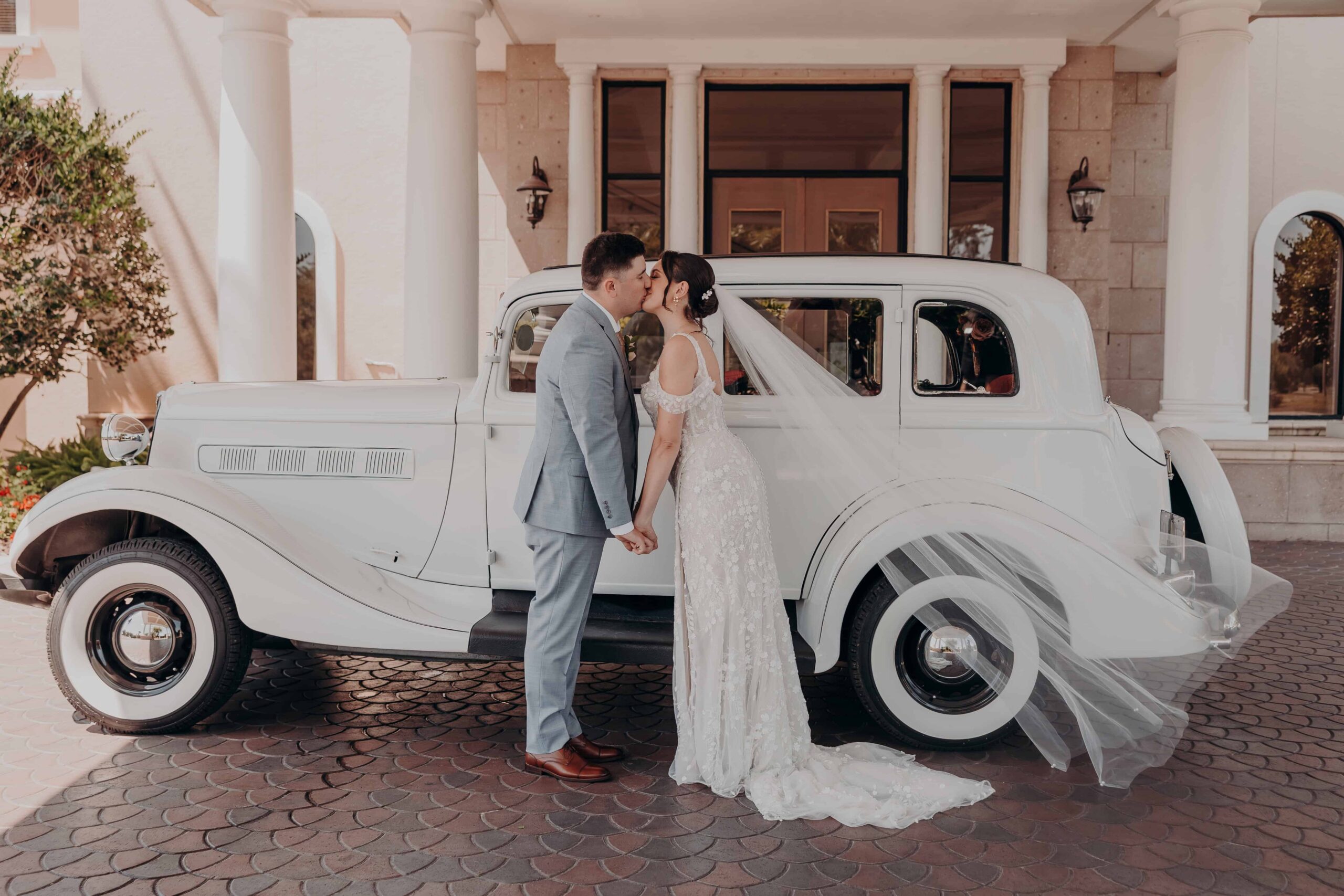 Classic couple portrait with vintage car at Lakewood Ranch Golf and Country Club after Brianna and Ryan Whitley Catholic church wedding