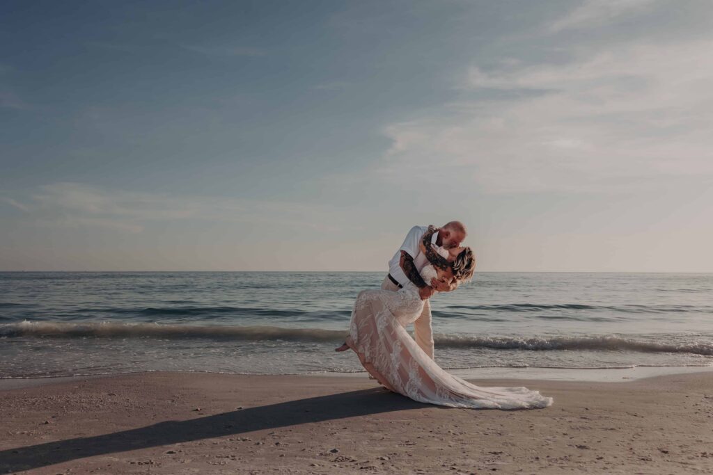 Couple dip silhouette Siesta Key beach sunset elopement Sarasota Florida
