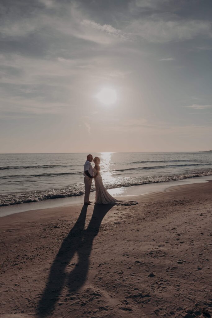Couple silhouette sunset beach elopement Siesta Key Sarasota