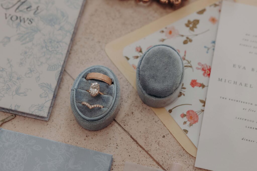 Engagement ring curved pave band and gold wedding band in dusty blue velvet ring box