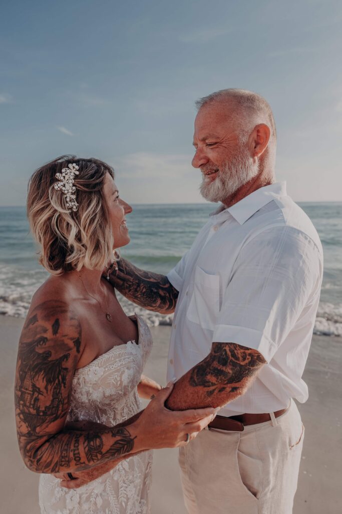 Family laughing together on Siesta Key beach during elopement portrait session Sarasota
