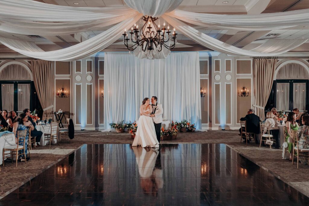 First dance wide shot in grand ballroom at Lakewood Ranch Golf and Country Club with ceiling draping and chandeliers