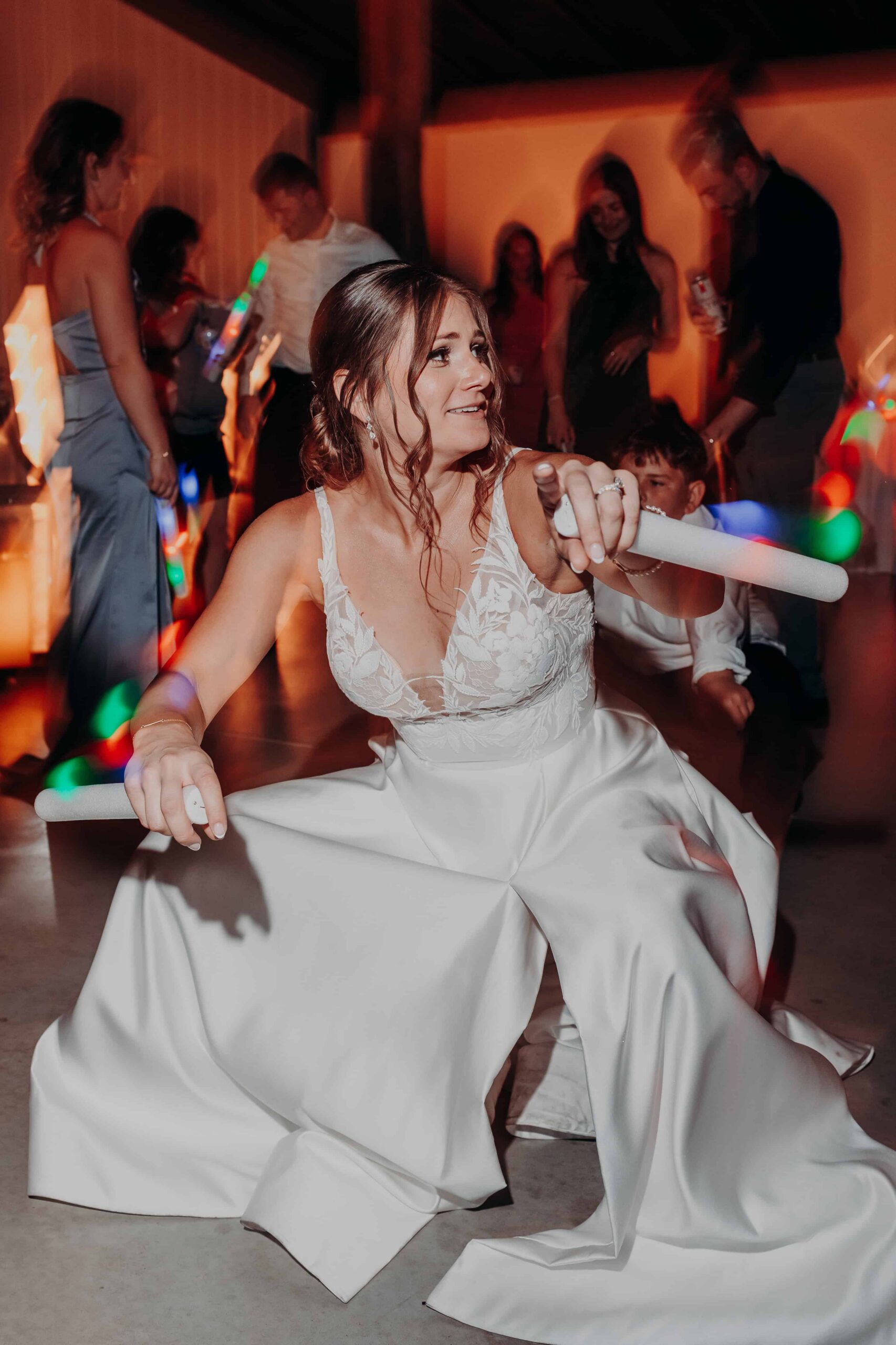 Hidden Acres wedding bride Hannah dancing at reception with glow sticks