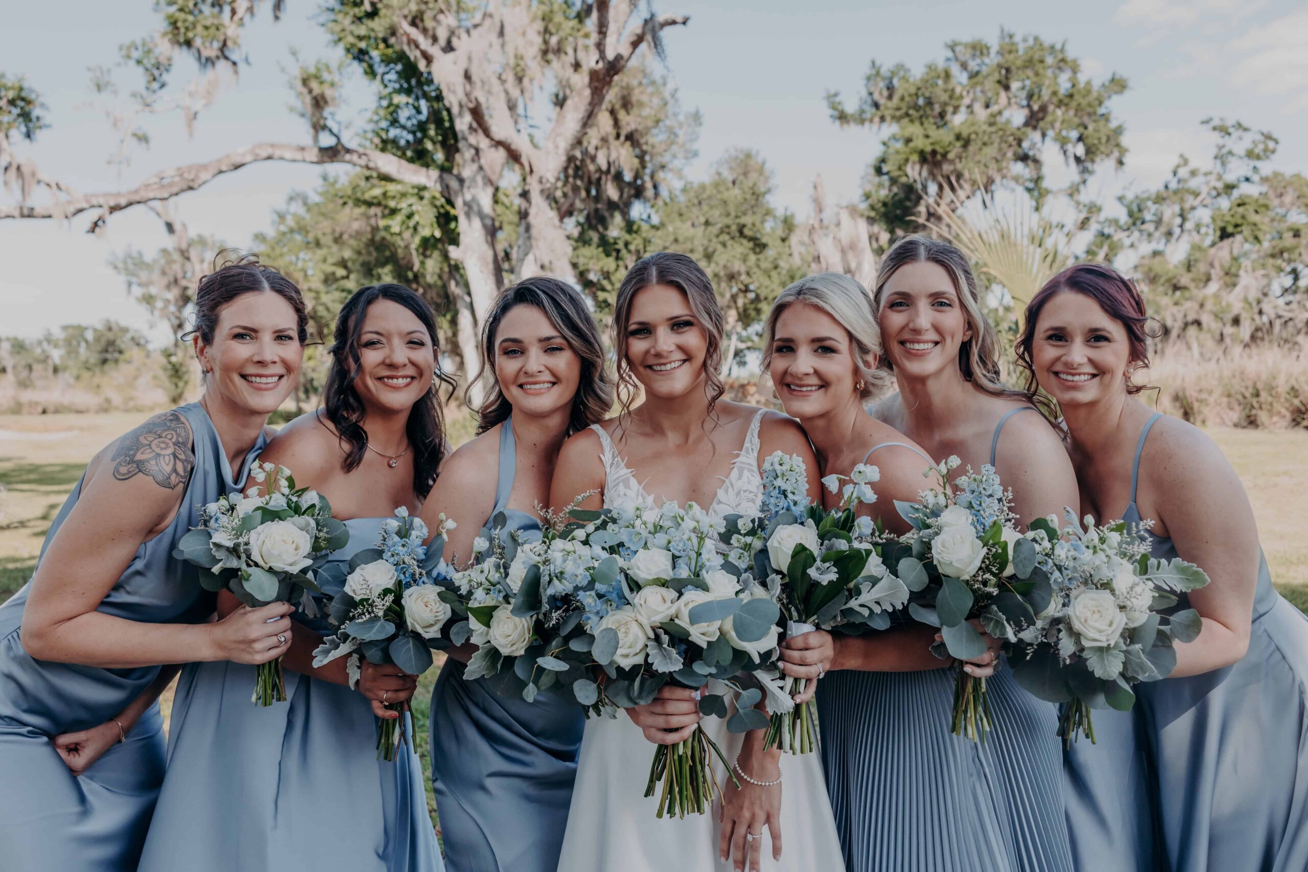 Hidden Acres wedding bridesmaids in blue dresses holding bouquets portrait