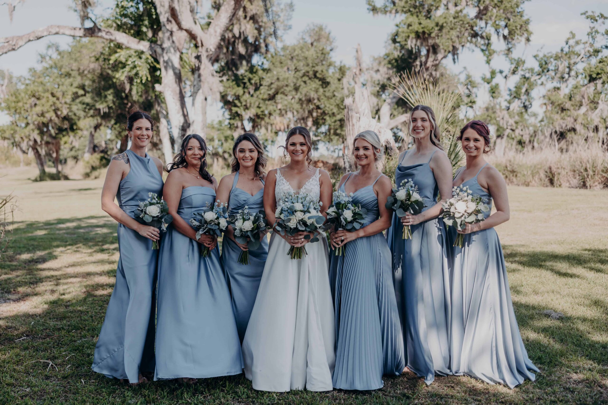 Hidden Acres wedding bridesmaids in dusty blue dresses group portrait