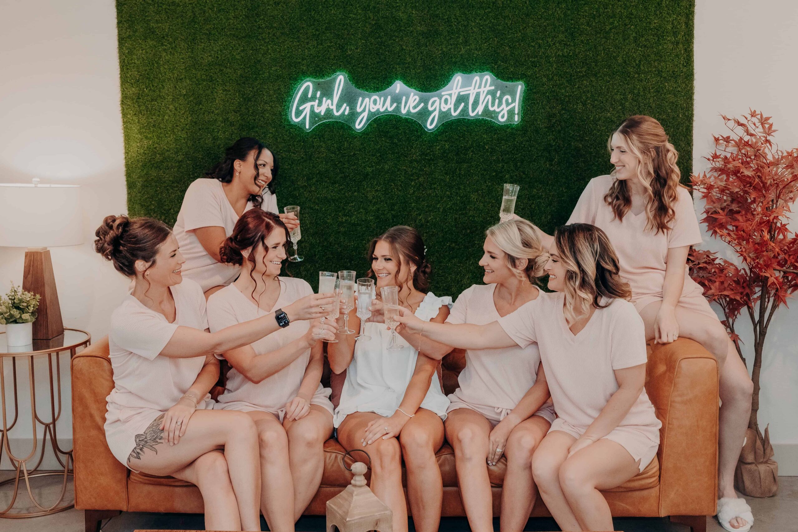 Hidden Acres wedding bridesmaids group champagne toast on sofa