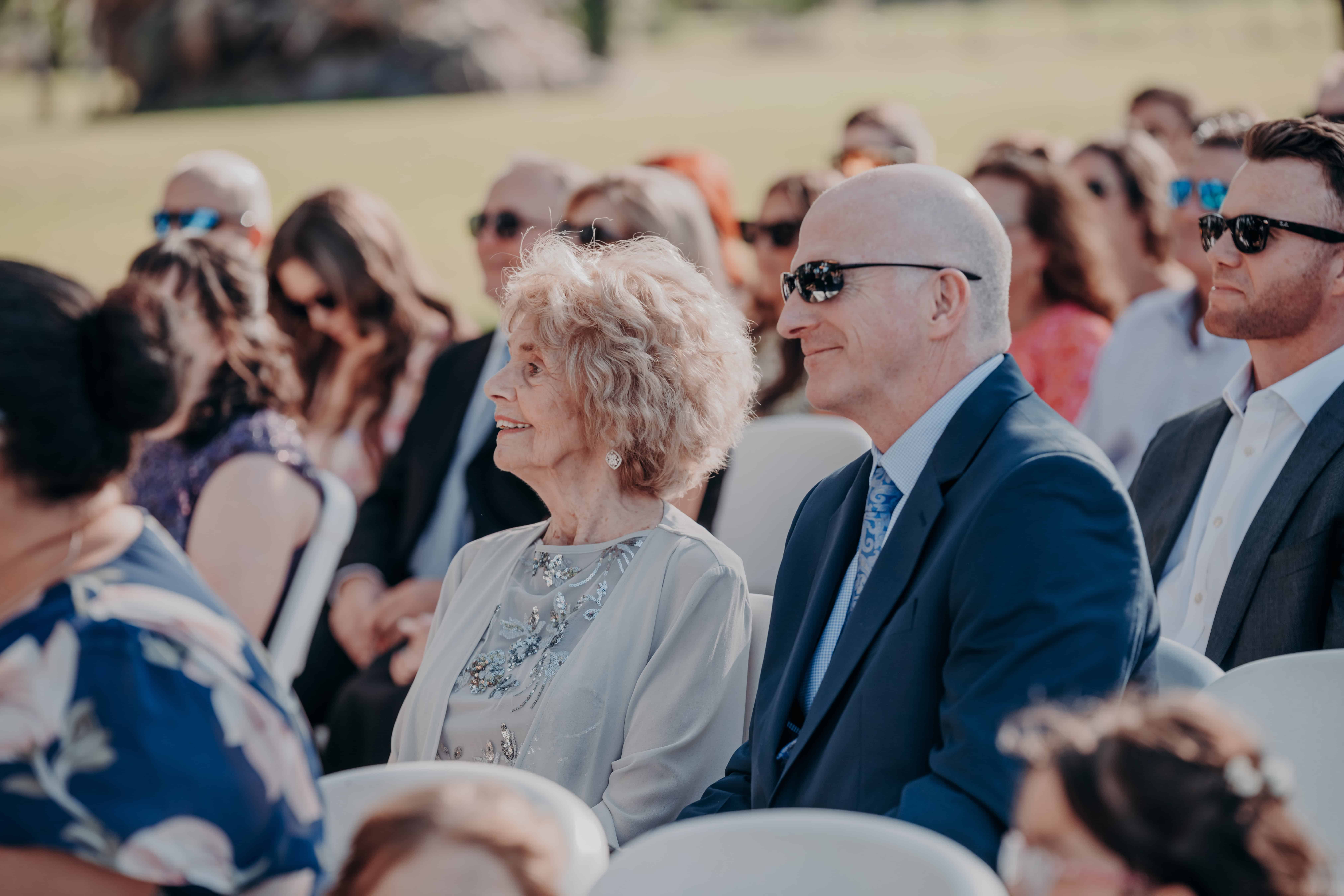 Hidden Acres wedding ceremony guests watching grandmother smiling front row