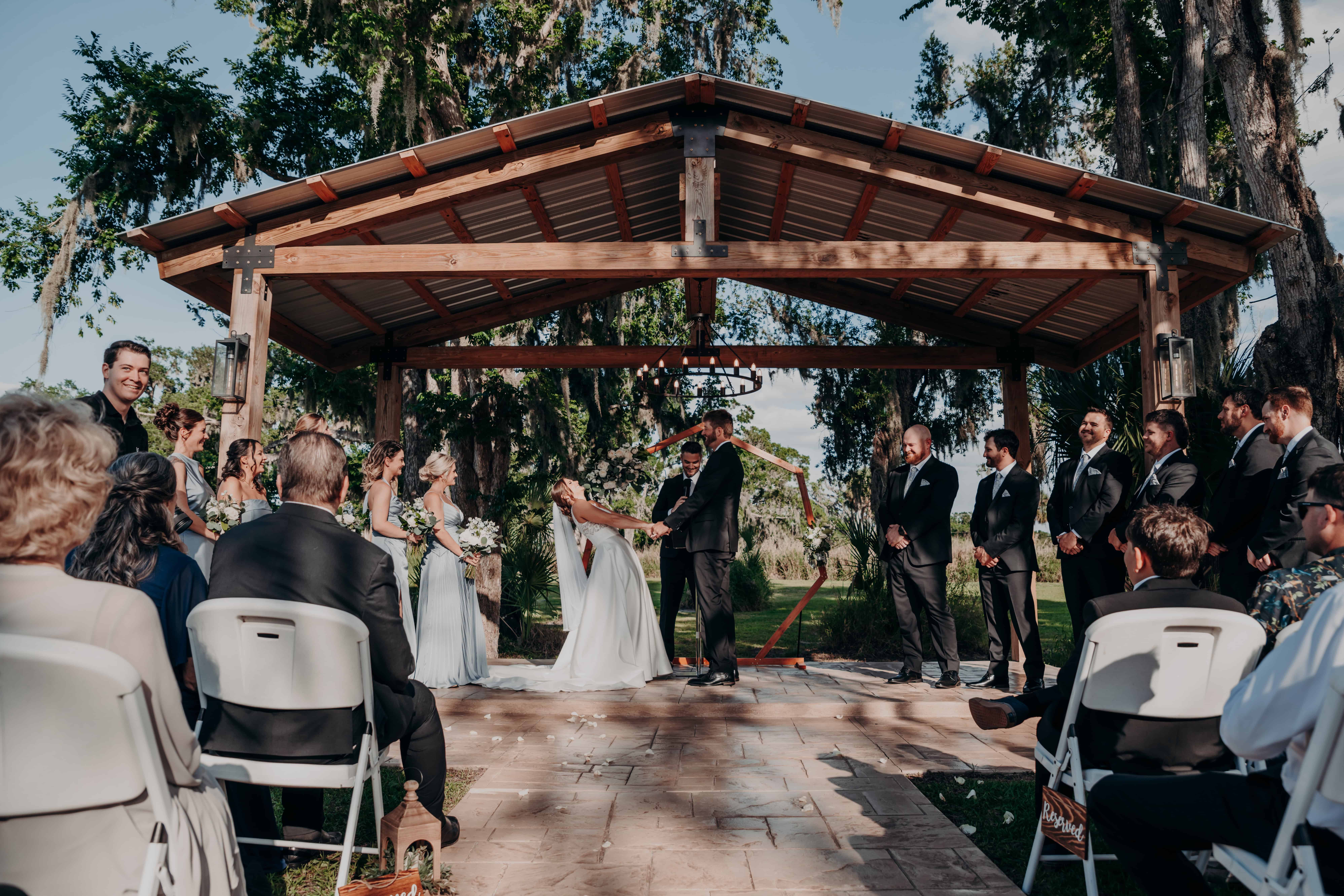 Hidden Acres wedding ceremony ring exchange at outdoor pavilion Palmetto Florida