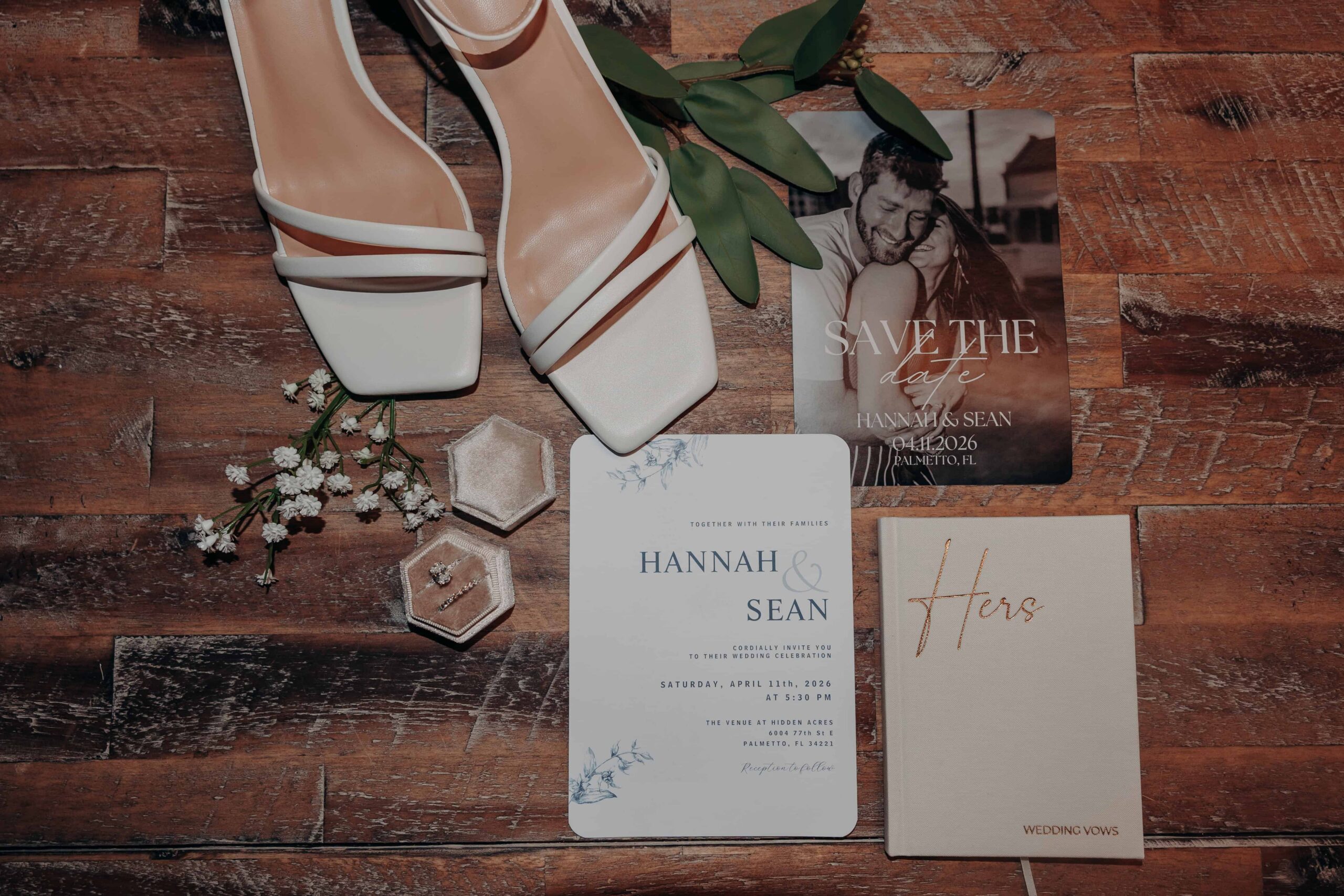 Hidden Acres wedding details flat lay invitation shoes vow book