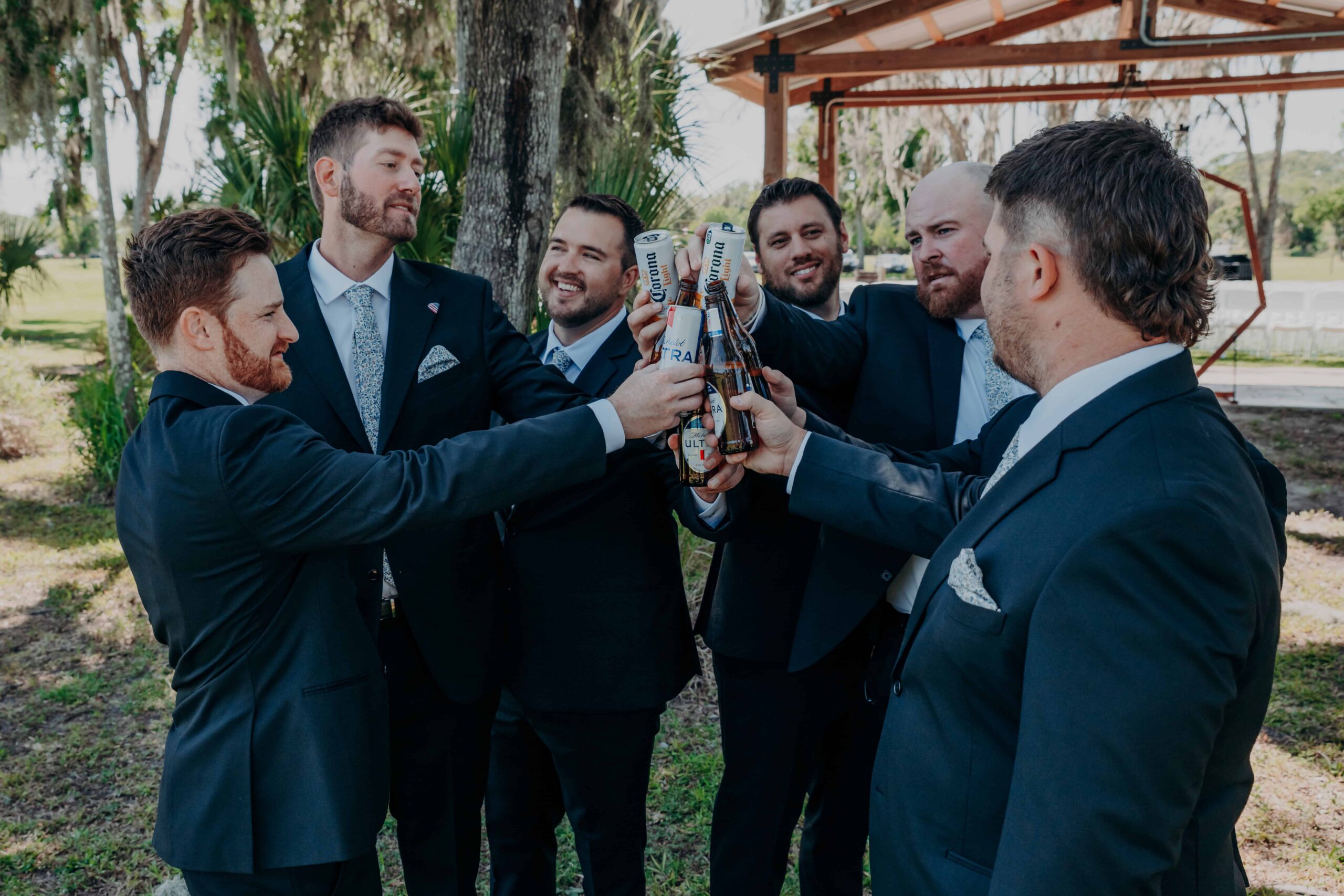 Hidden Acres wedding groomsmen beer toast cheers