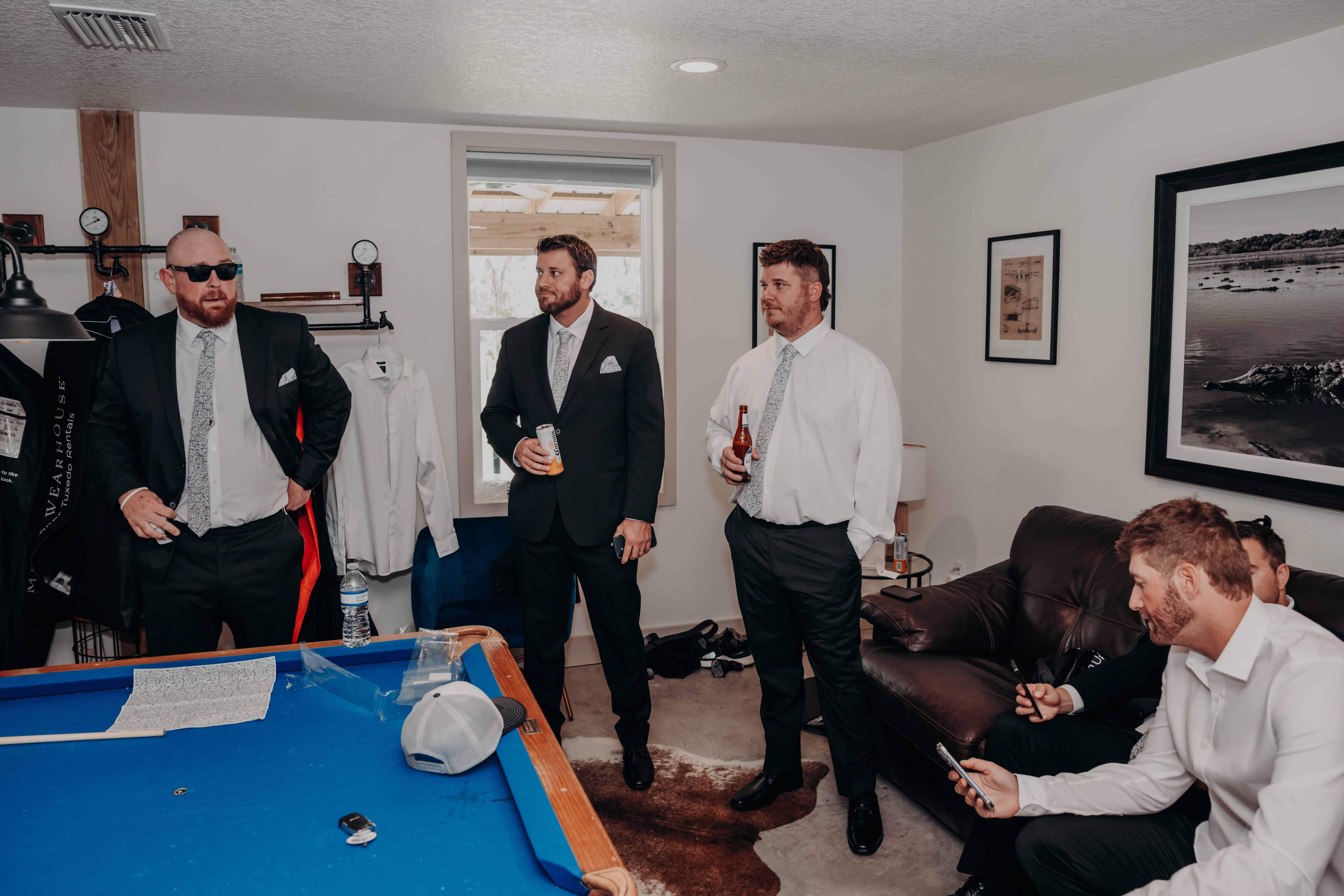 Hidden Acres wedding groomsmen getting ready by pool table