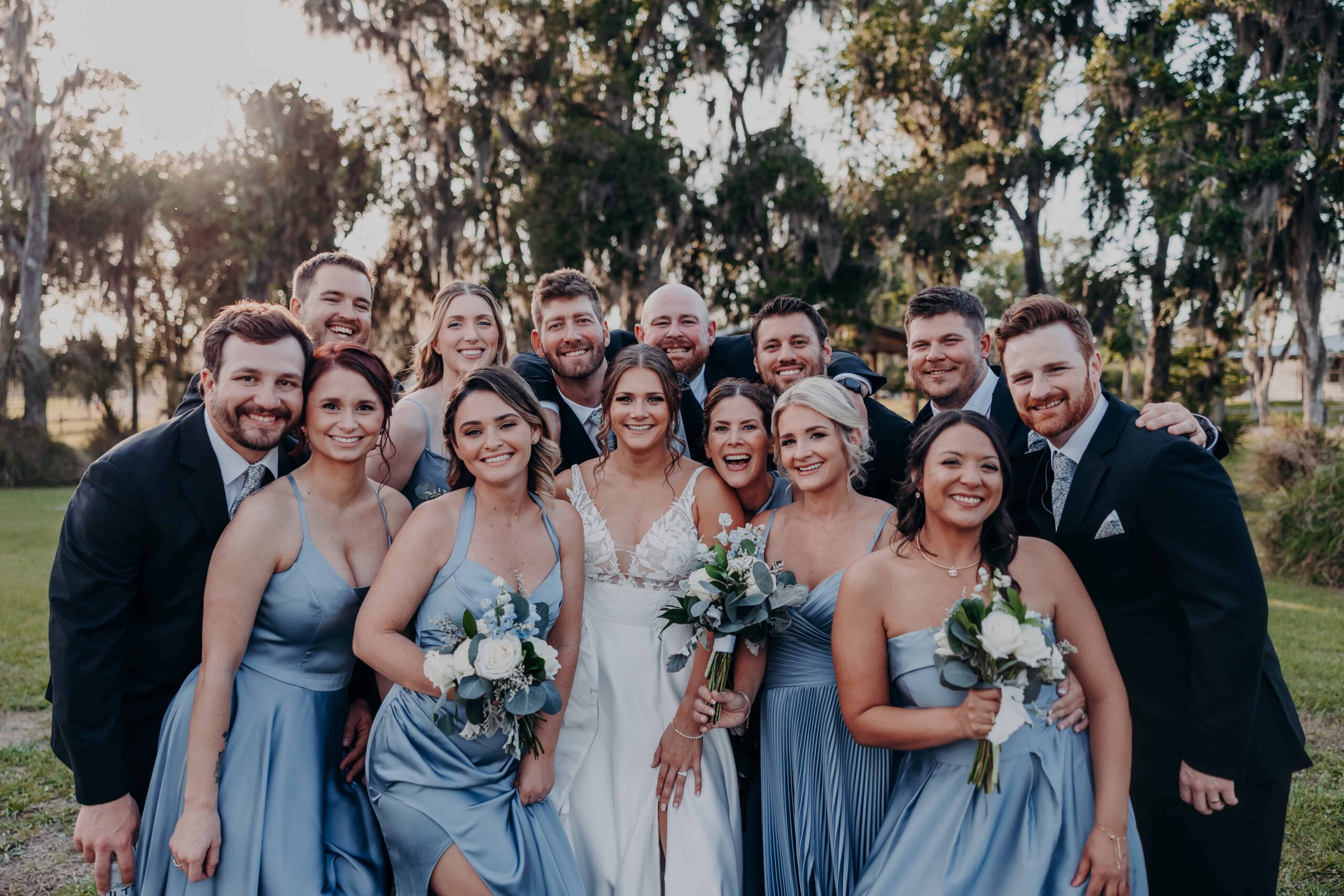 Hidden Acres wedding party group smiling at golden hour