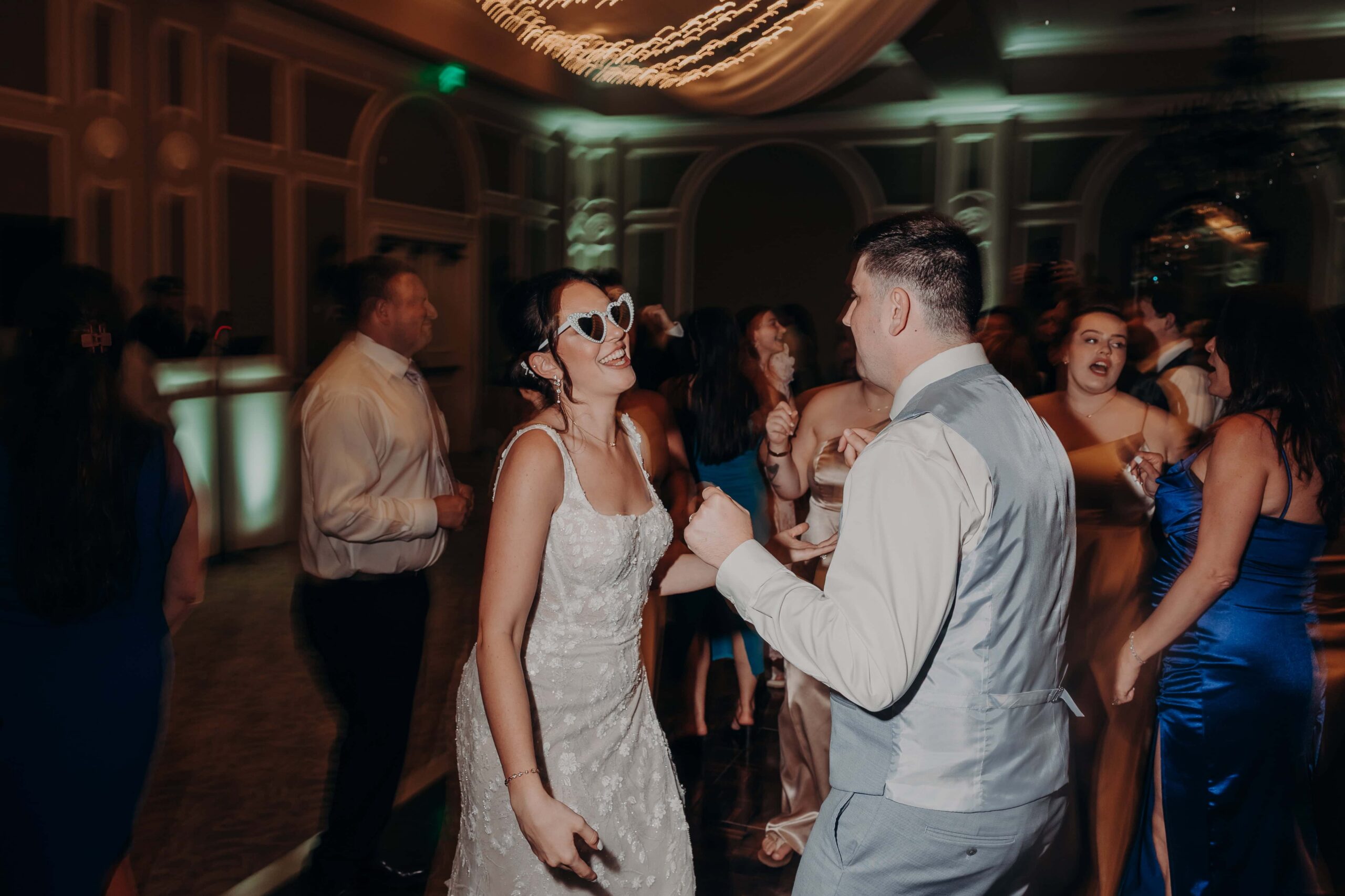 High energy wedding reception dancing with foam sticks at Lakewood Ranch Golf and Country Club for Brianna and Ryan Whitley wedding