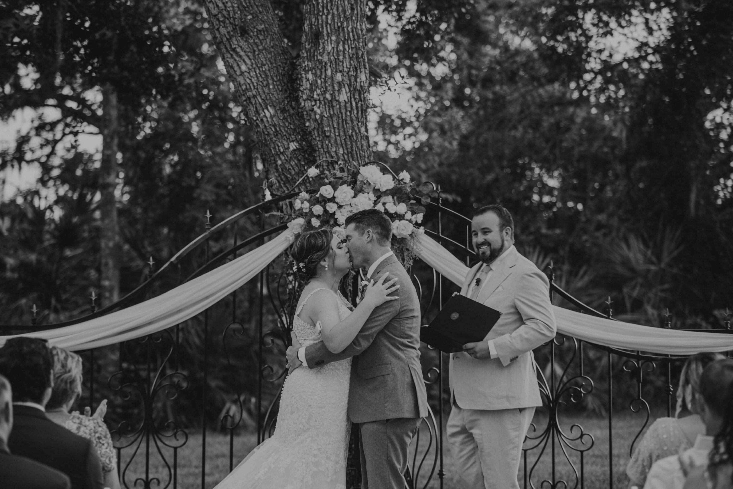 First kiss under ornate iron arch at Hudson Manor Diamond C Ranch Myakka City Florida