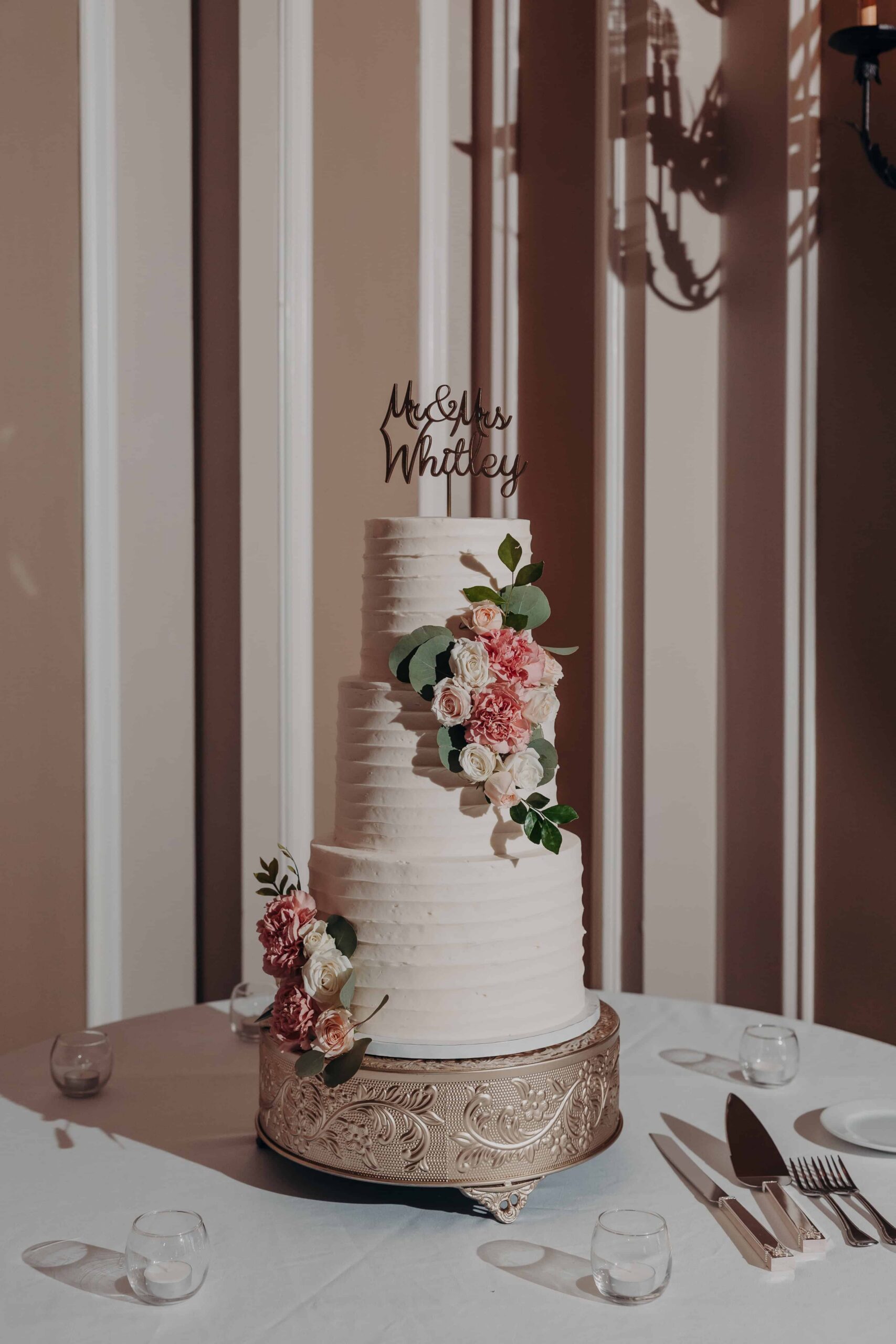 Lakewood Ranch Golf and Country Club ballroom with white ceiling draping fairy lights iron chandelier and floral centerpieces for Brianna and Ryan wedding reception