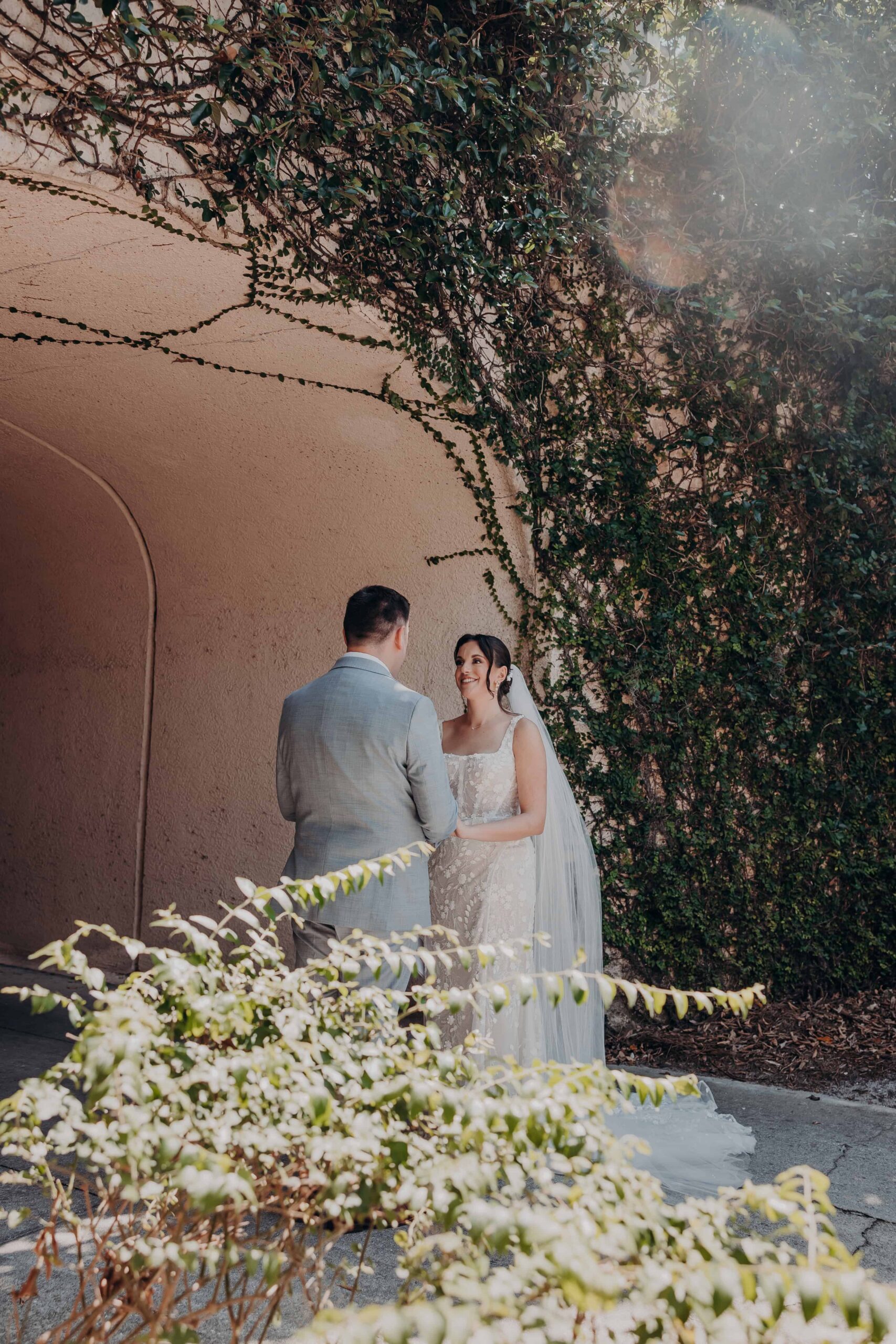 Romantic couple portrait in the ivy-covered tunnel arch at Lakewood Ranch Golf and Country Club during Brianna and Ryan Whitley wedding