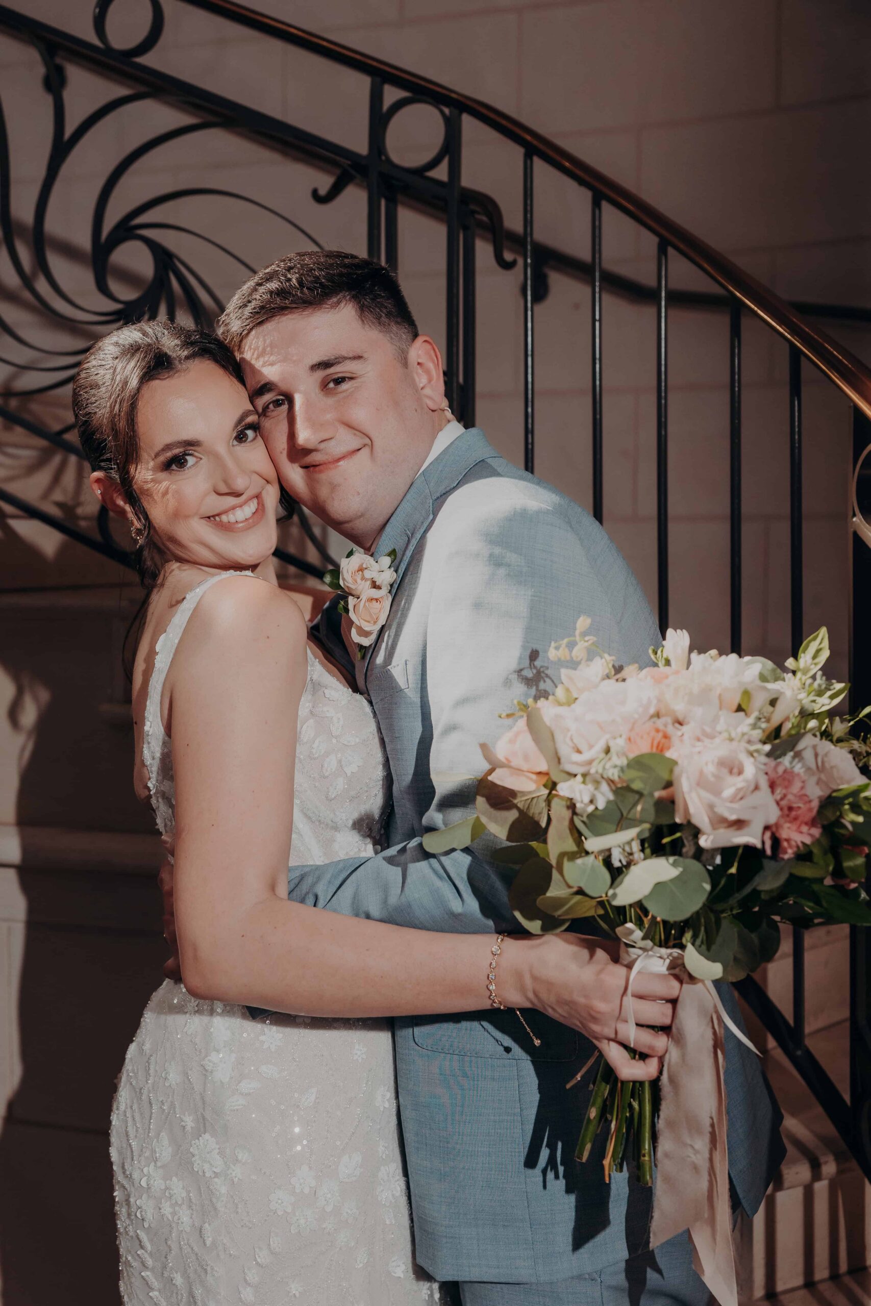 Romantic kiss portrait on the ornate staircase at Lakewood Ranch Golf and Country Club photographed by Angela Moon Photography Sarasota