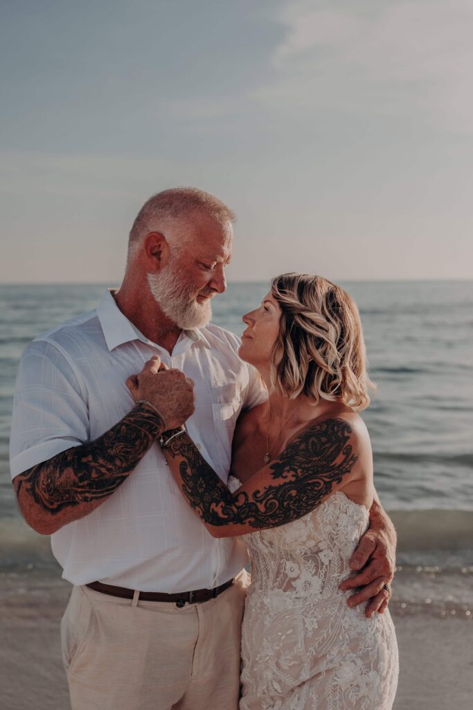 Romantic sunset silhouette of Sarah and Jasen at their Siesta Key beach elopement