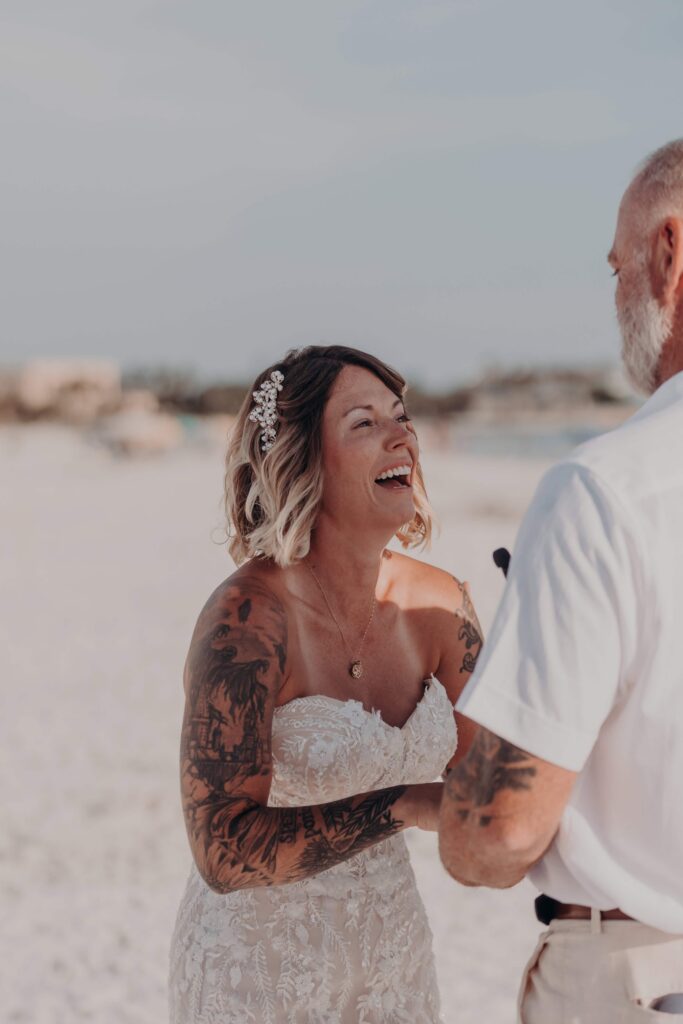 Sarah and Jasen exchanging rings during their intimate Siesta Key beach ceremony