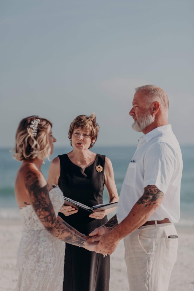 Sarah and Jasen standing together on Siesta Key beach before their elopement ceremony