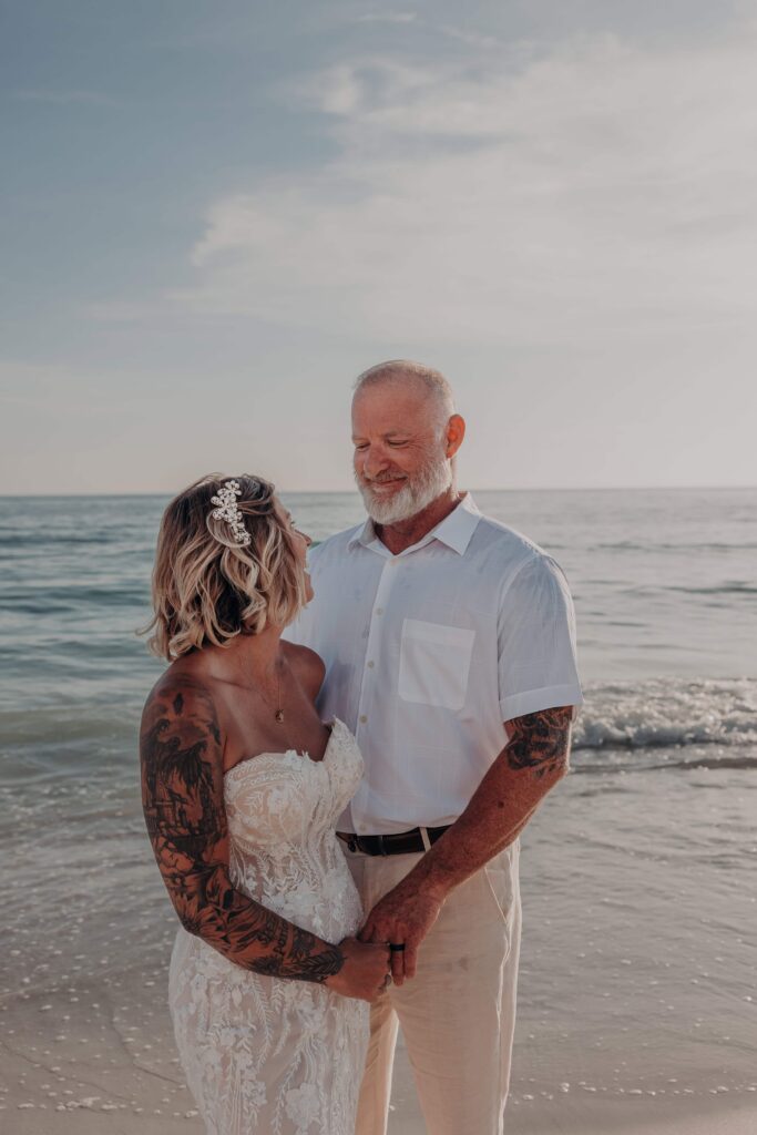 Sarah barefoot on Siesta Key white sand at golden hour during beach elopement portraits