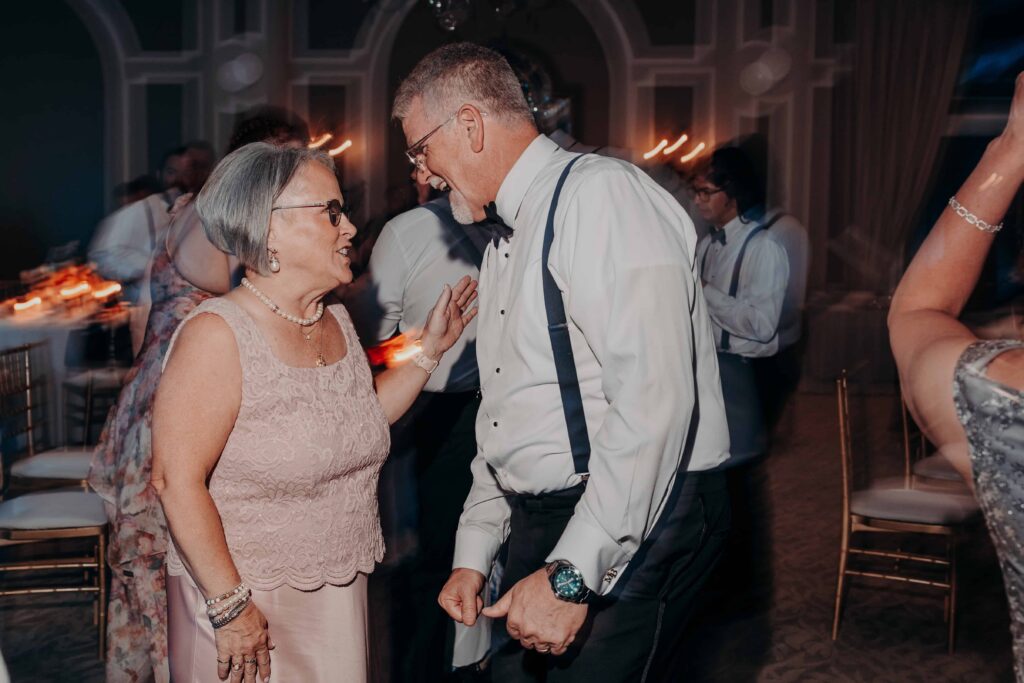 Wedding guests laughing and dancing on packed dance floor at Lakewood Ranch Golf and Country Club reception