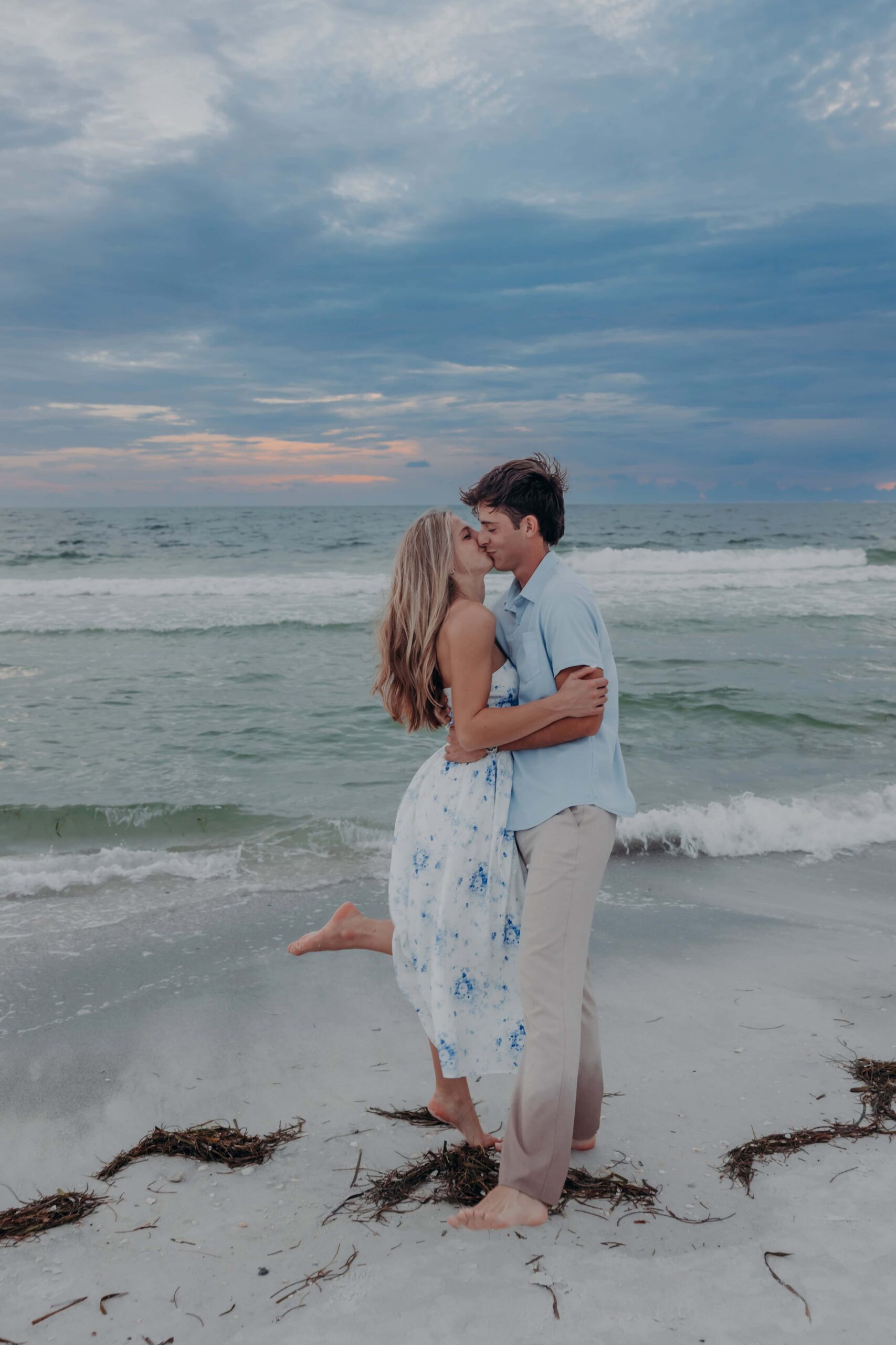 Quinten hugging Suzanna from behind at sunset on Lido Beach, Sarasota