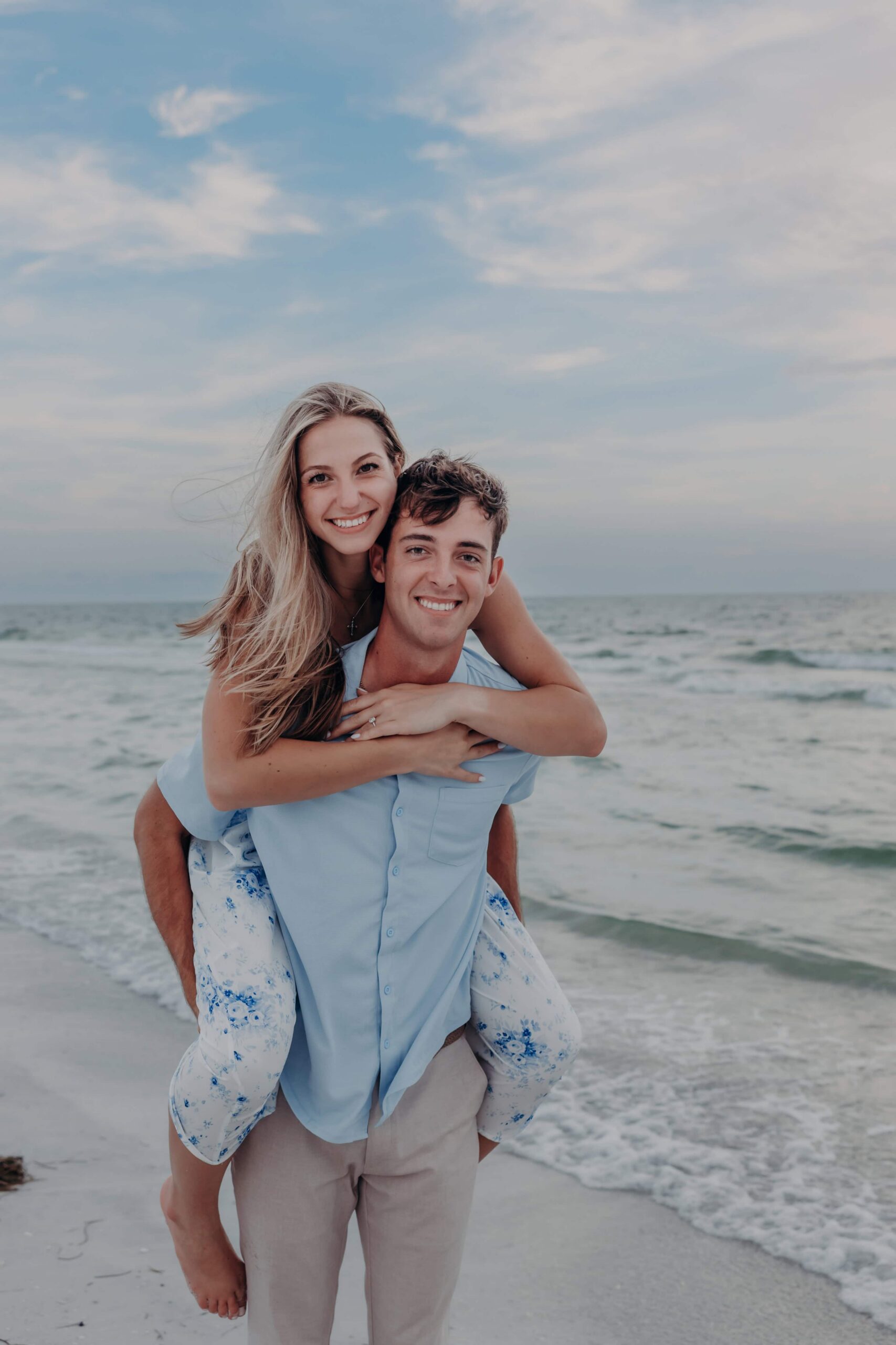 Piggyback ride during Lido Beach engagement photos in Sarasota