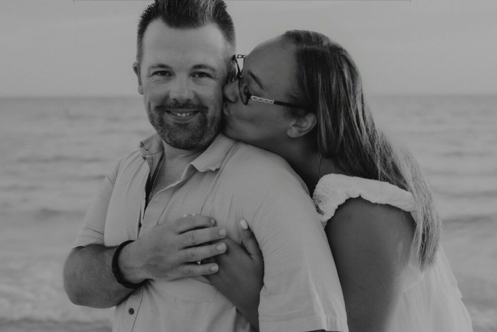 siesta key beach proposal black and white cheek kiss ring ocean sarasota