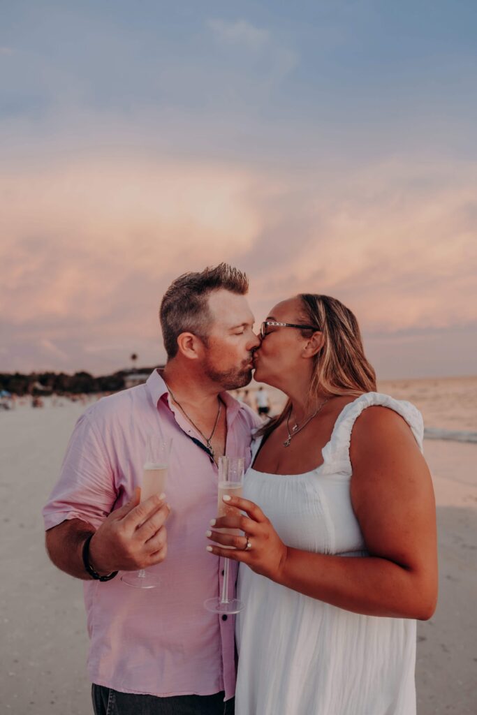 siesta key beach proposal couple champagne kiss pink sky sarasota