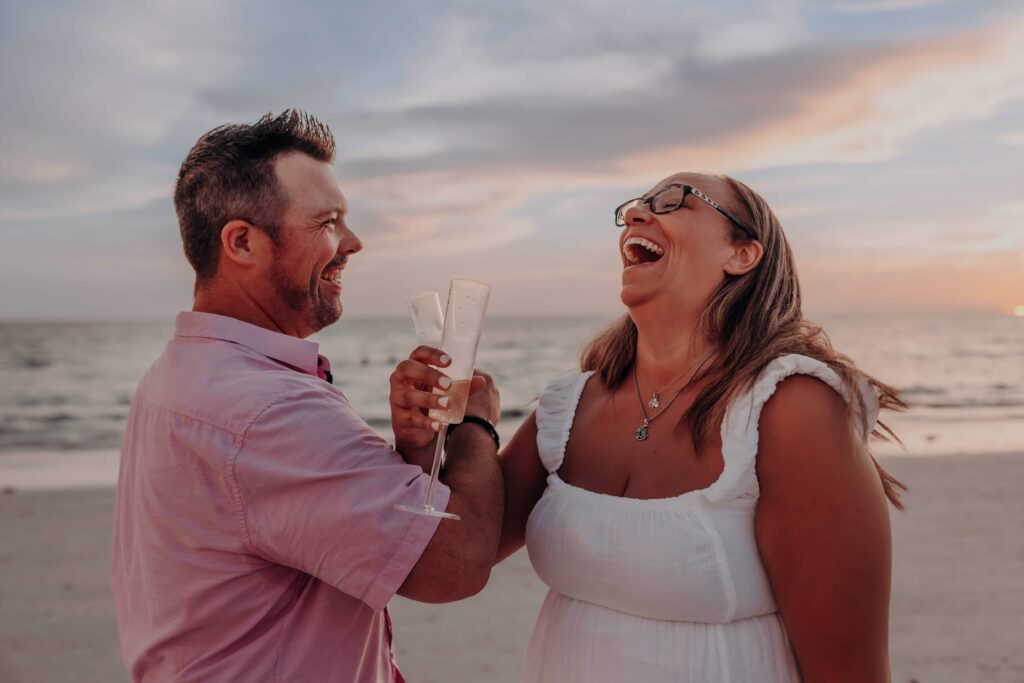 siesta key beach proposal couple champagne toast laughing sarasota
