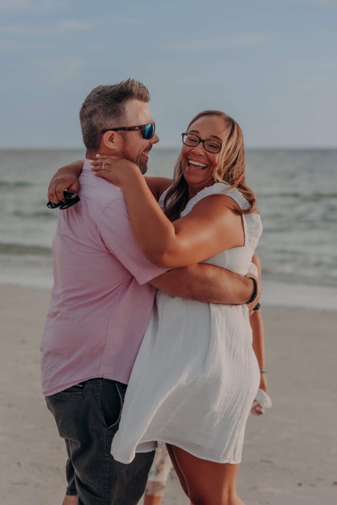 siesta key beach proposal couple embracing laughing sarasota