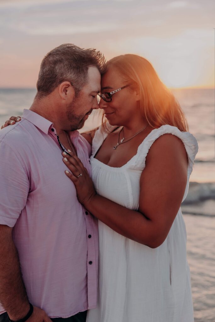 siesta key beach proposal couple forehead to forehead golden glow sarasota