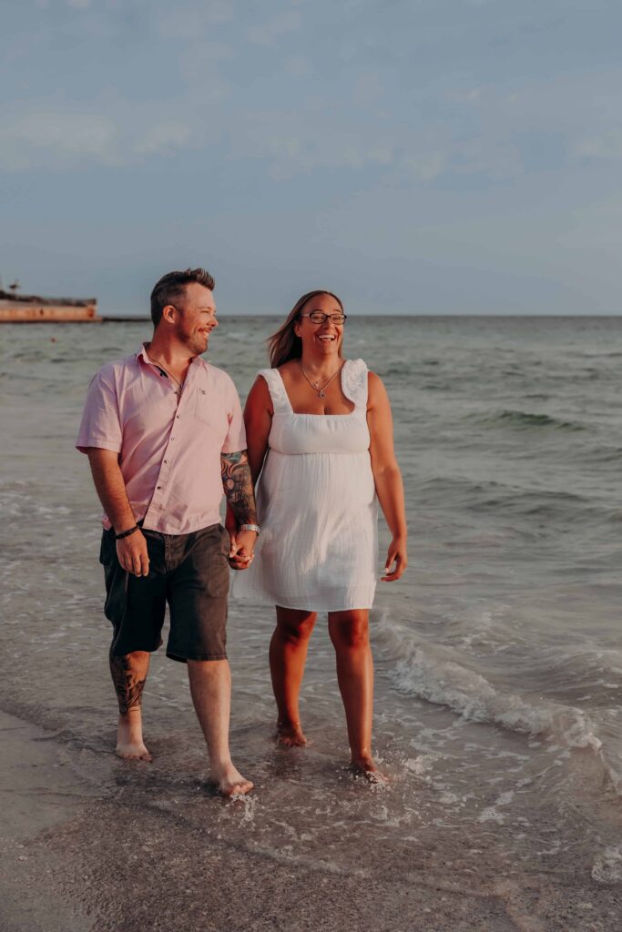 siesta key beach proposal couple golden hour walking surf sarasota