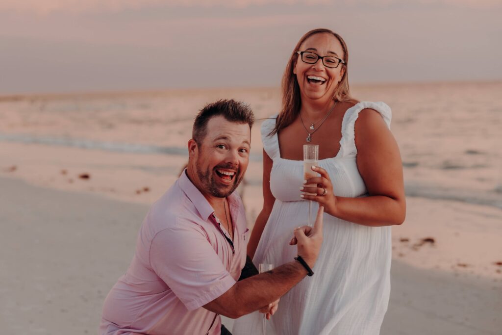 siesta key beach proposal couple goofy fun champagne celebration sarasota