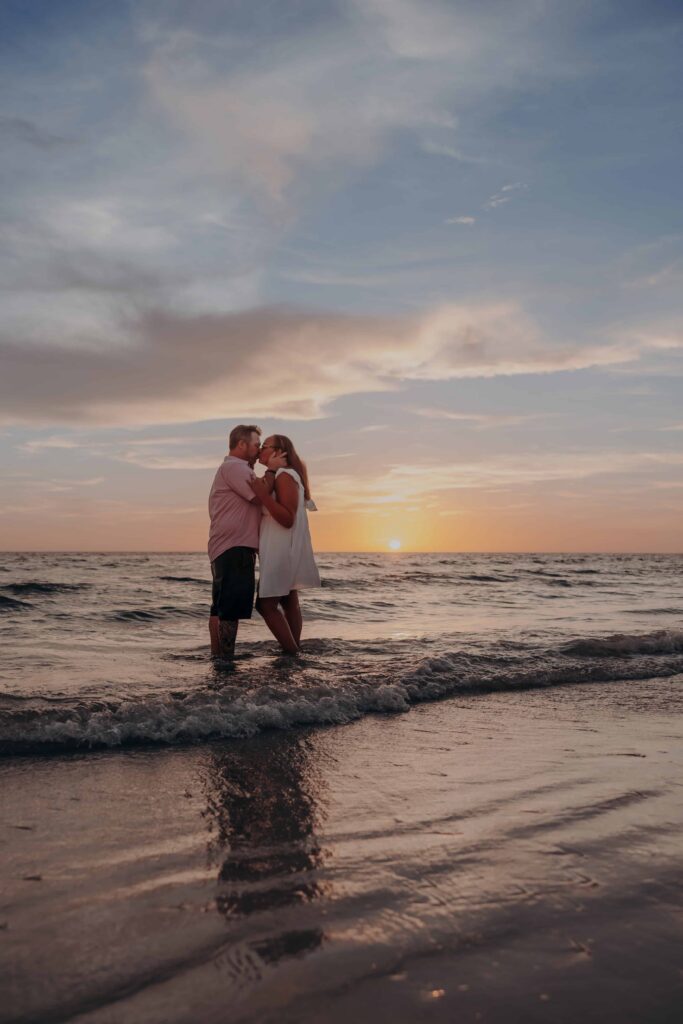 siesta key beach proposal couple kissing surf wide sunset horizon sarasota