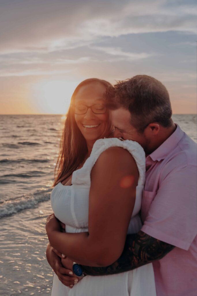siesta key beach proposal couple sunset embrace laughing ocean sarasota