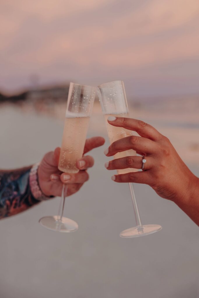 siesta key beach proposal engagement ring champagne clink detail sarasota