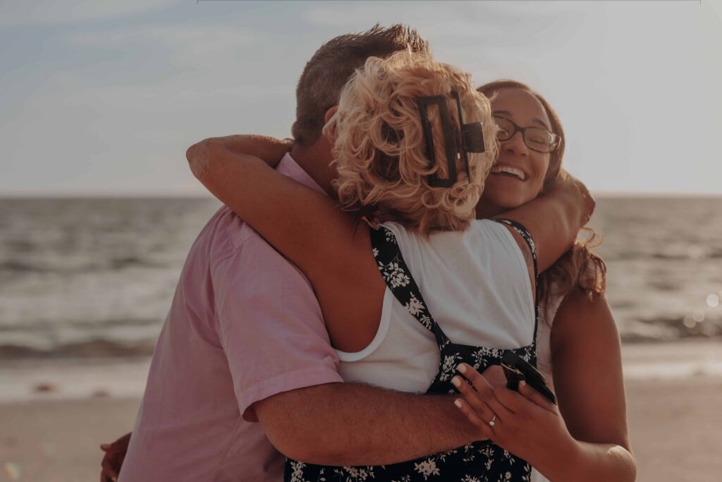 siesta key beach proposal family celebration mom hug sarasota
