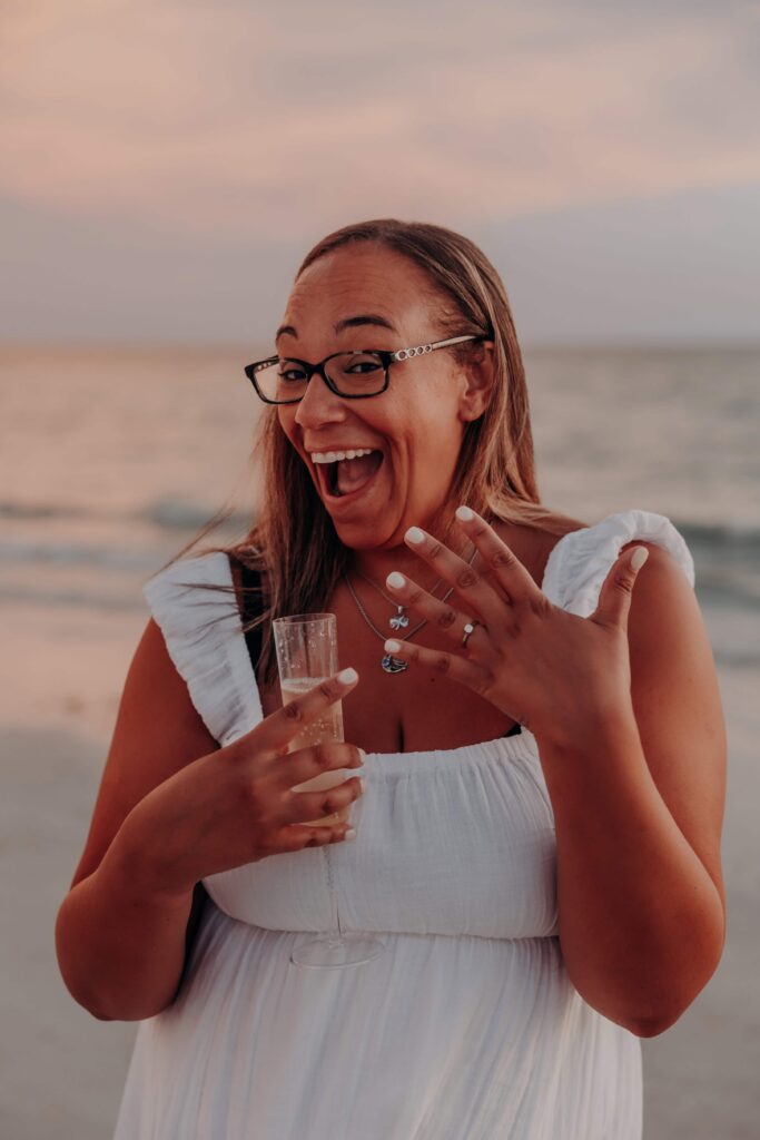siesta key beach proposal fiancee flashing engagement ring champagne sarasota