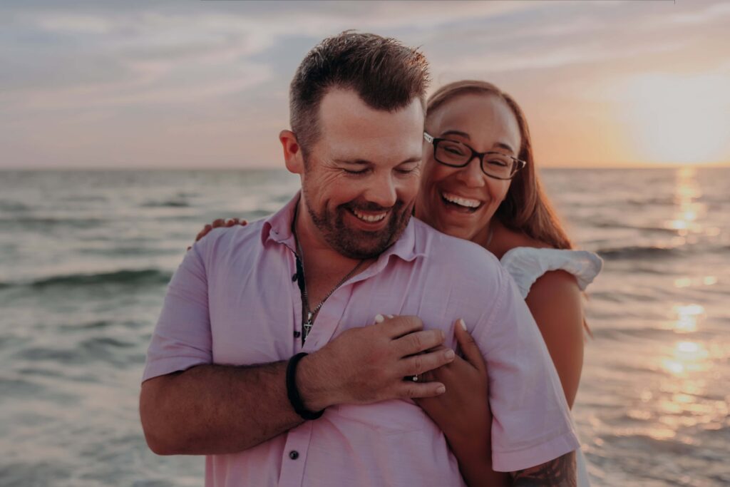 siesta key beach proposal fiancee hugging from behind ring pastel sky sarasota