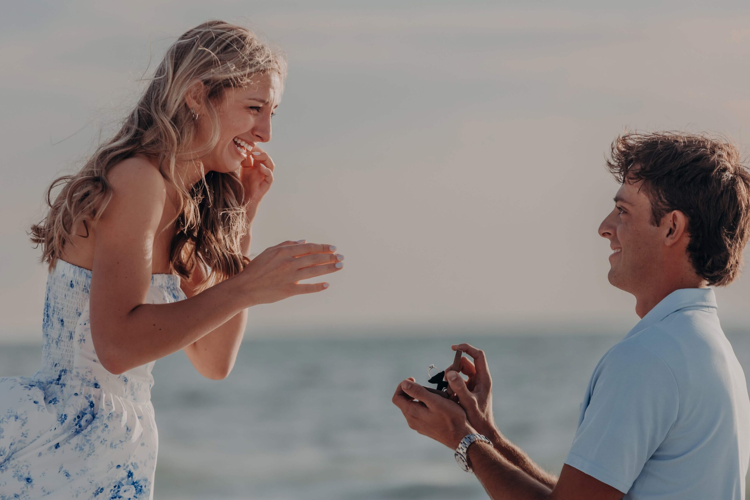 Suzanna laughing in surprise moments after Quinten proposed on Lido Beach
