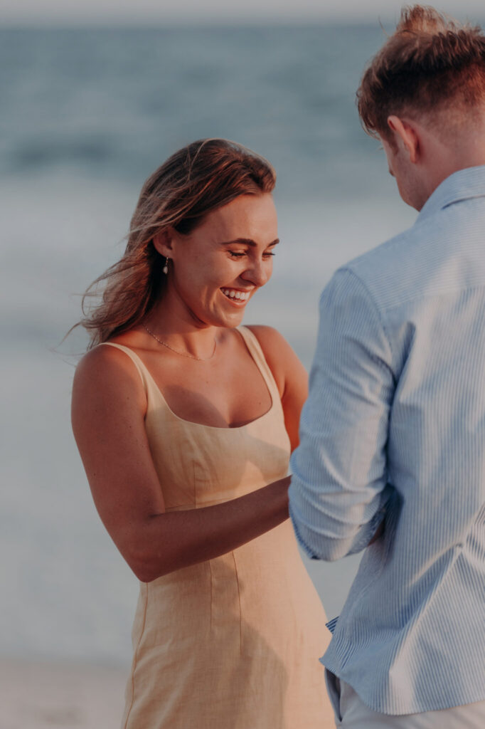 Michael and Regan walking together on the sand at sunset