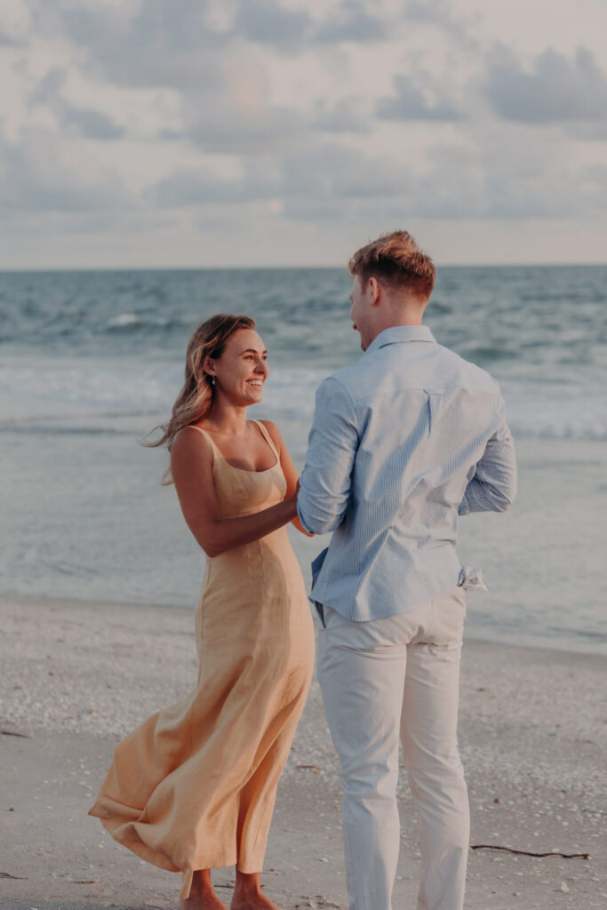 Black and white portrait of Michael and Regan embracing on the beach