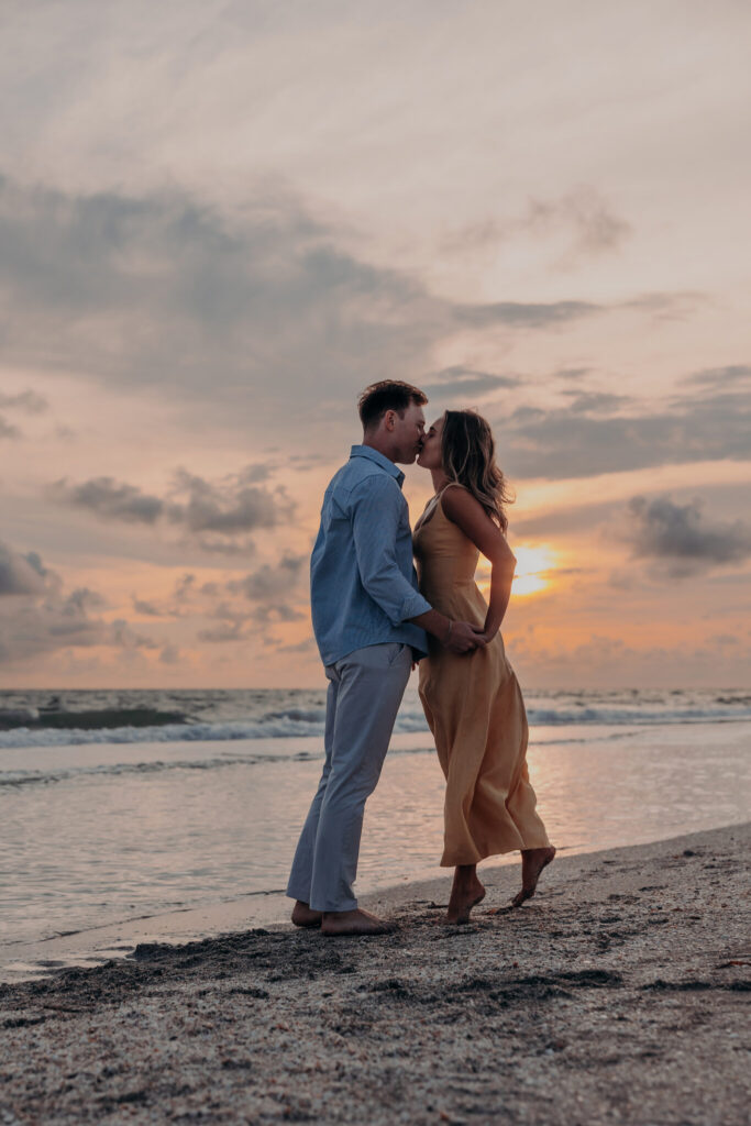 Michael and Regan walking together on the sand at sunset