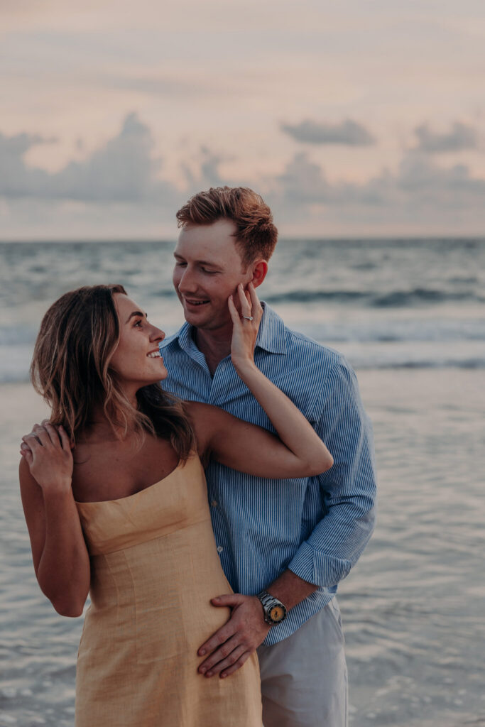 Black and white portrait of Michael and Regan embracing on the beach